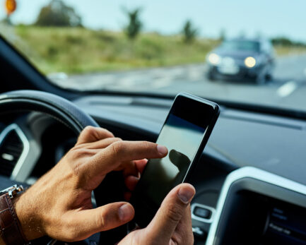 Man using cellphone while driving