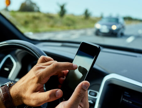Man using cellphone while driving