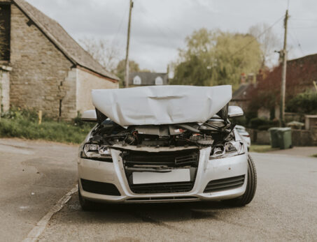 wrecked car parked street after car crash