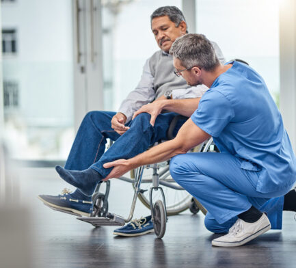 helping a man in a wheelchair
