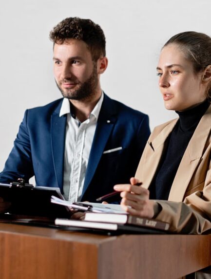 Photo by Mikhail Nilov: https://www.pexels.com/photo/woman-discussing-documents-while-at-the-podium-8730782/