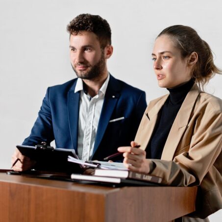Photo by Mikhail Nilov: https://www.pexels.com/photo/woman-discussing-documents-while-at-the-podium-8730782/