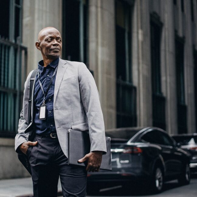 Photo by Ono Kosuki: https://www.pexels.com/photo/respectable-black-businessman-standing-on-street-5648410/