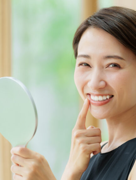 Woman smiling showing her dental implants
