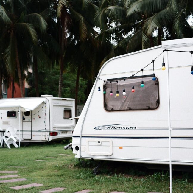 Photo by Mew wy. : https://www.pexels.com/photo/trailer-vans-on-green-grass-2848438/