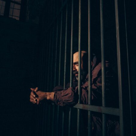 Photo by ahmet öktem: https://www.pexels.com/photo/a-prisoner-standing-behind-the-bars-26743057/